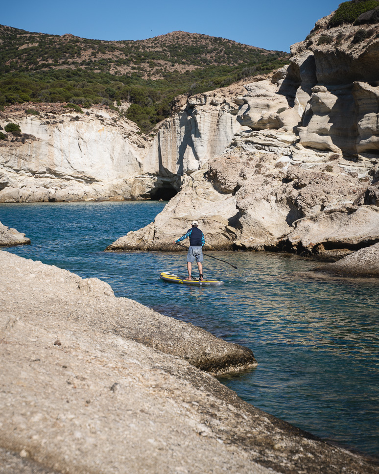 Guy on a paddle board at Kleftiko beach in Milos