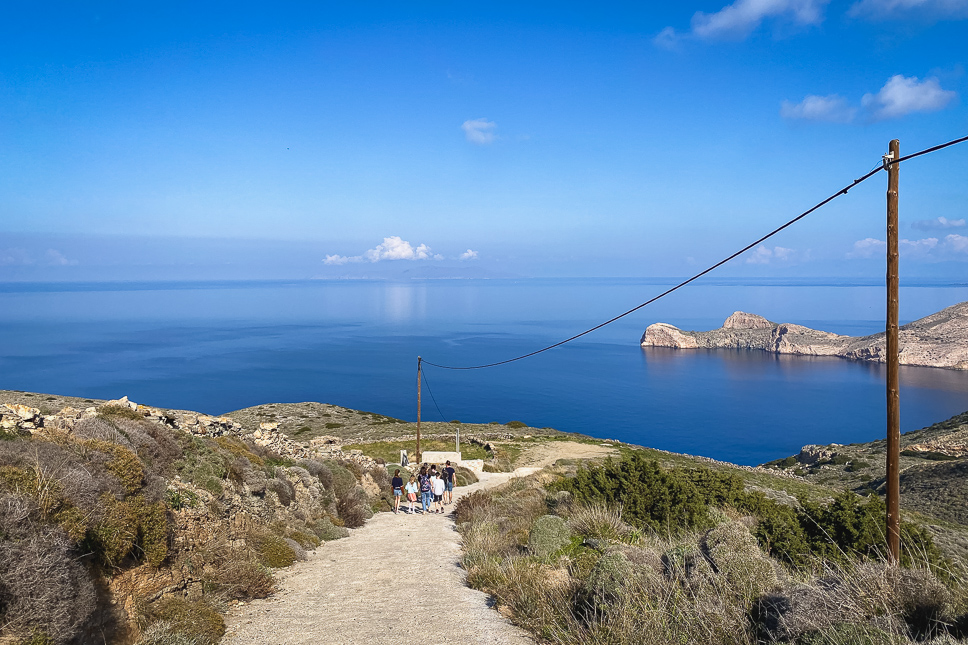 Family walking down the road leading to the trailhead of the hike to Agios Stefanos